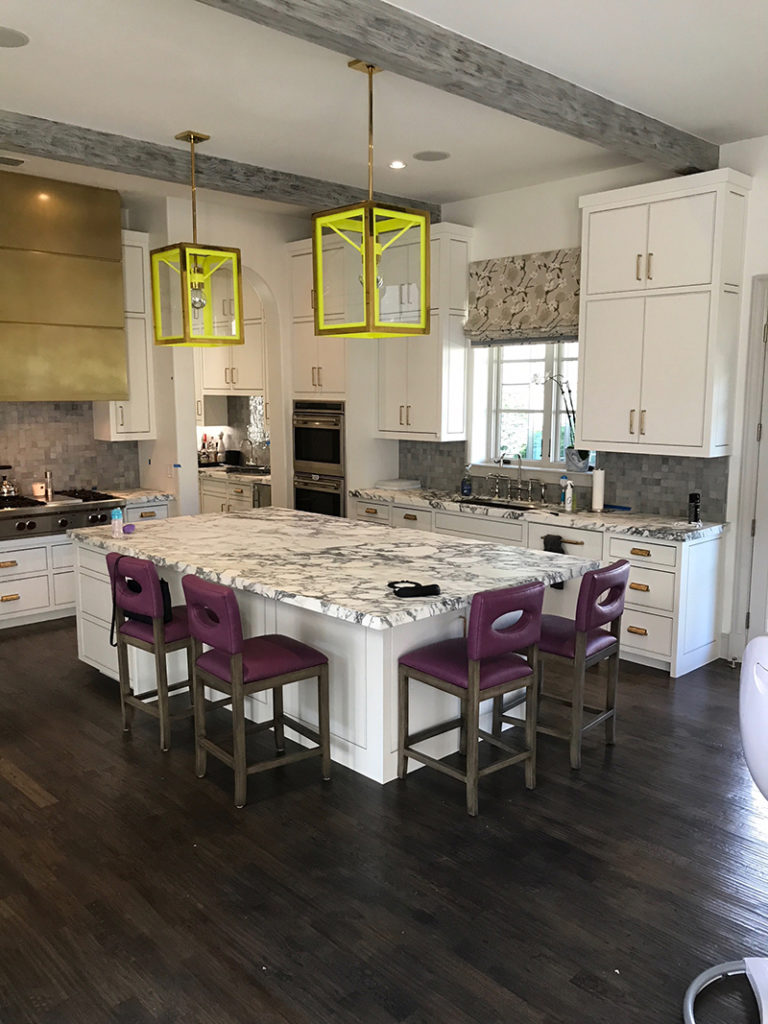 White kitchen remodel with yellow light frames