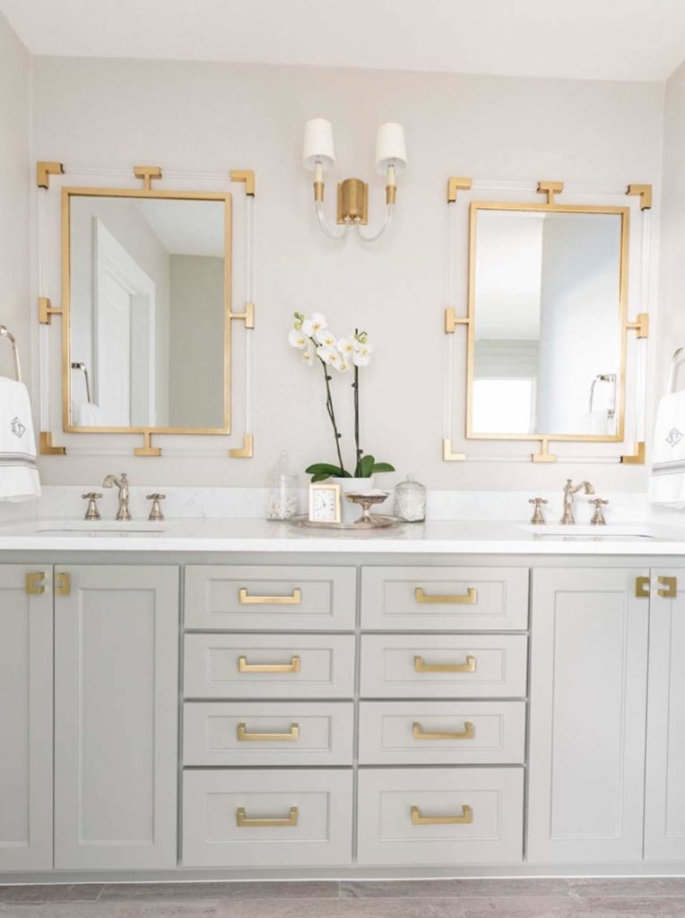Modern white shaker style bathroom vanity with gold fixtures