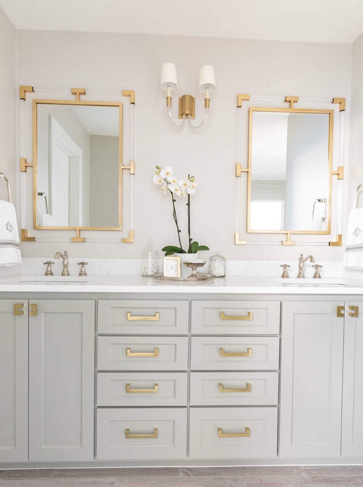 Modern white shaker style bathroom vanity with gold fixtures